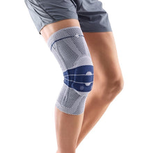 Load image into Gallery viewer, Genutrain Knee Brace shown on the right leg with the knee in a slightly bent position. Brace shown is colour titan.